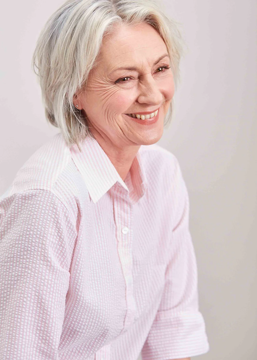 Woman wears an adapted smart shirt in pale pink