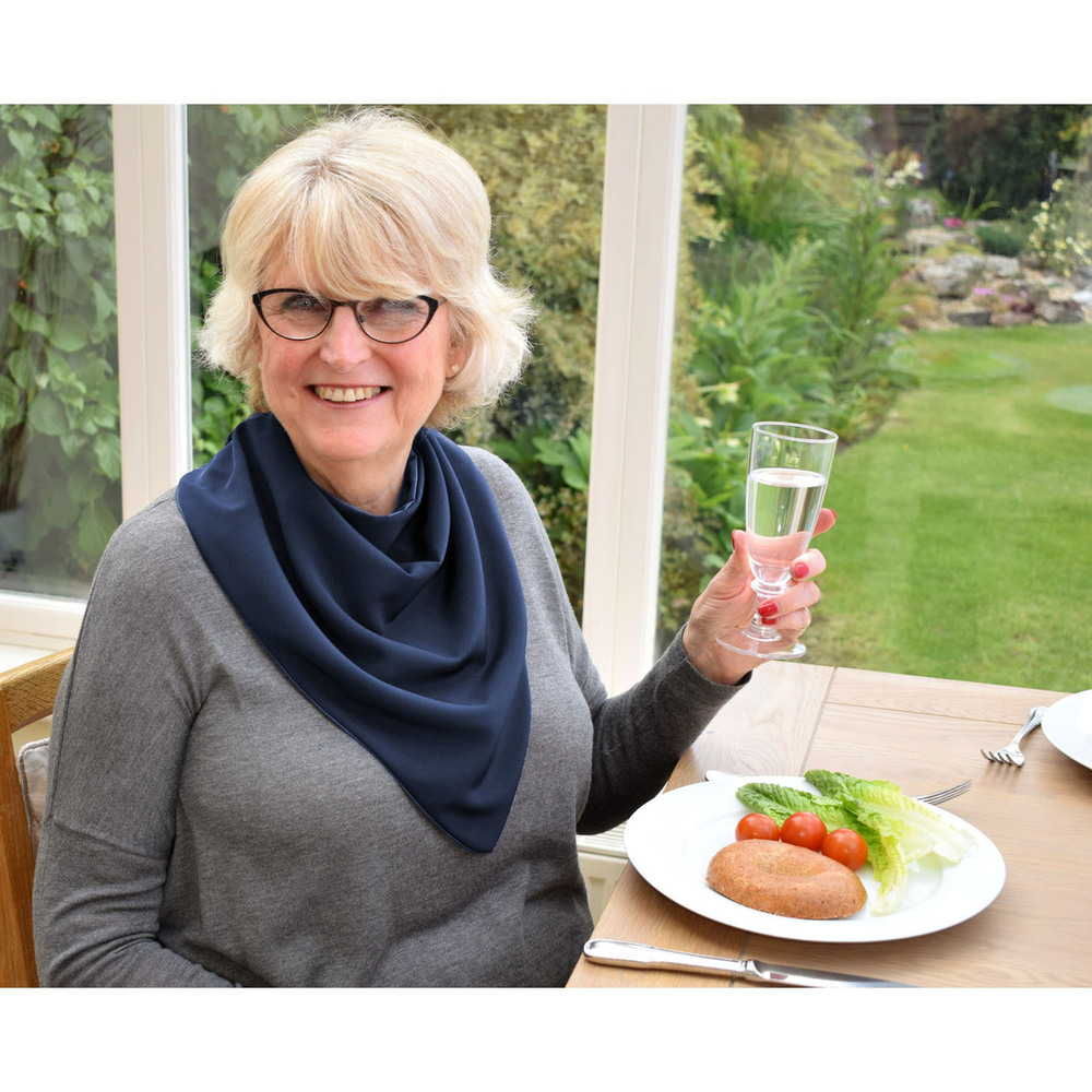 Woman wears long elegant bib whilst eating 