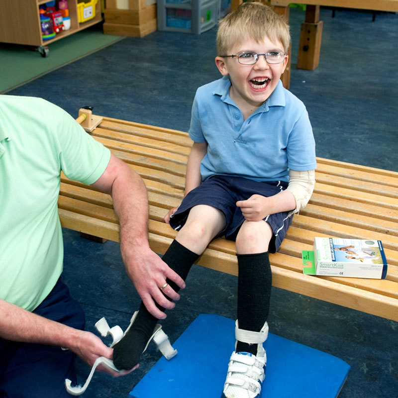 Smiling boy wears long seamless socks