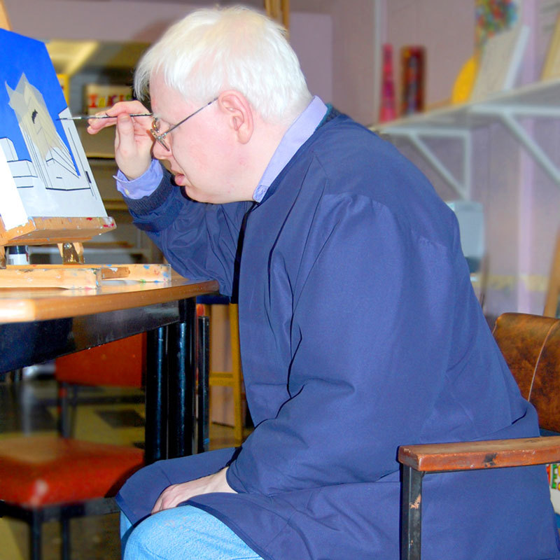 Man paints whilst wearing a waterproof overall