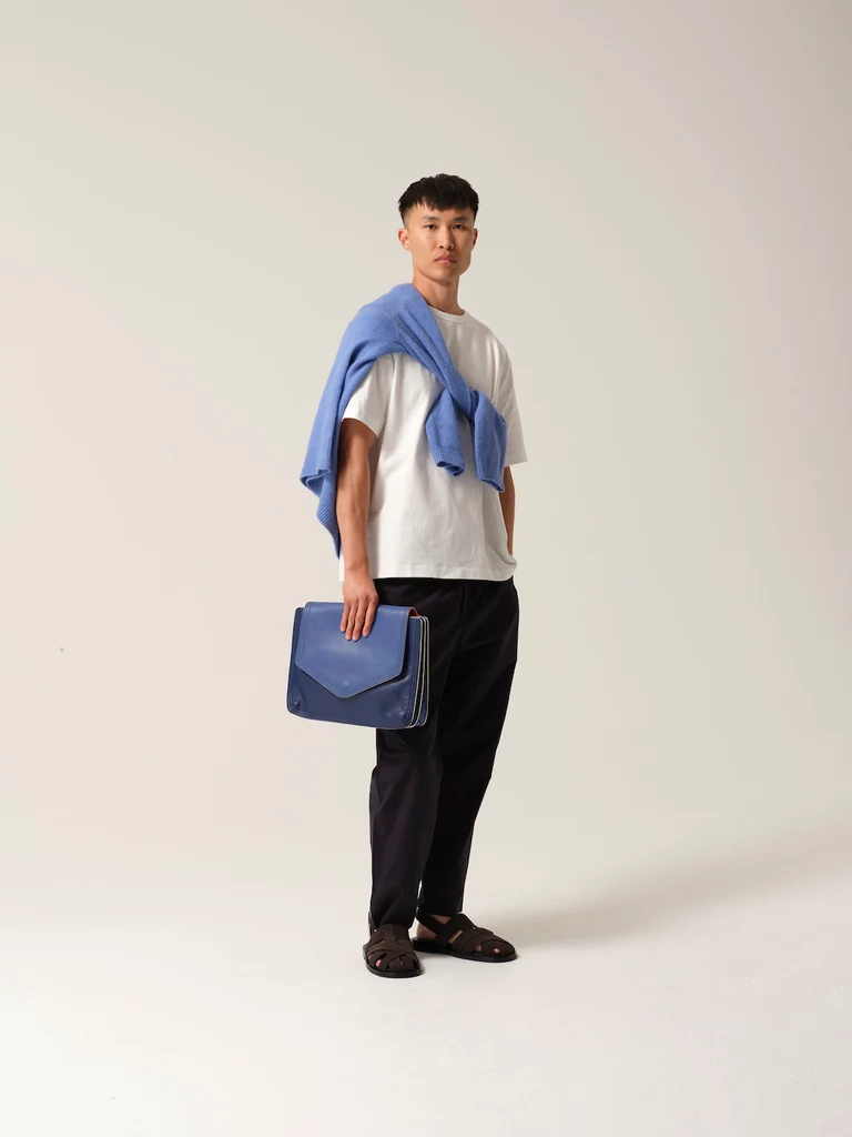 Man carries Doctor's Notes bag in blue