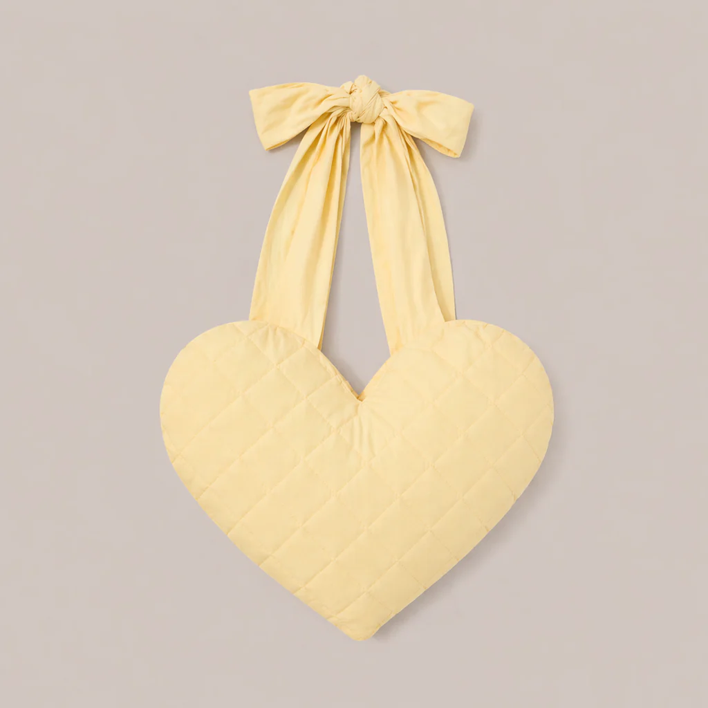 Heart shaped pillow in yellow