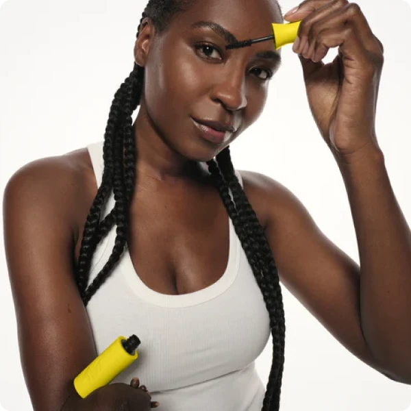 A model with upper limb difference applies lashscape mascara.