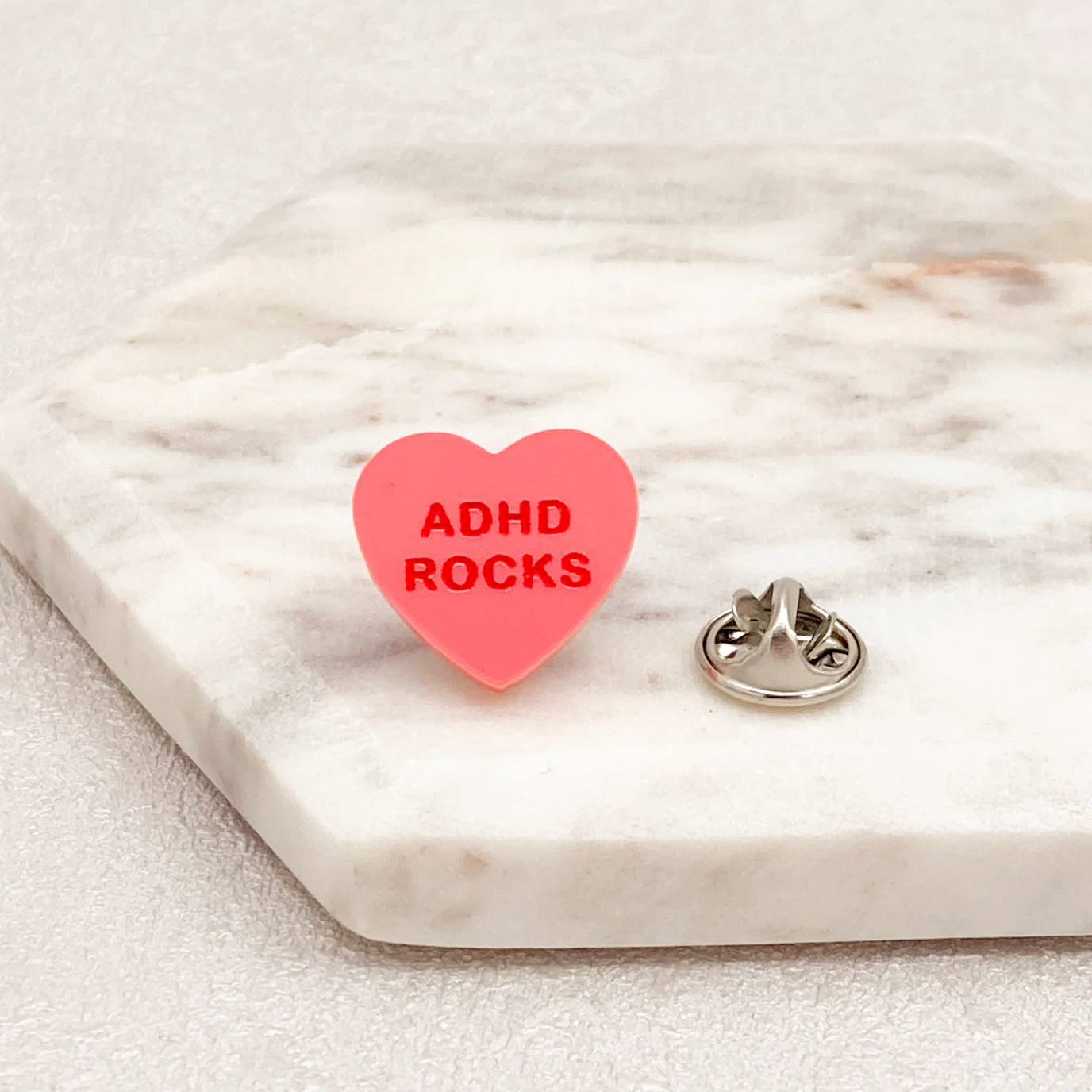 Pink Pin Badge with ADHA rocks written in red