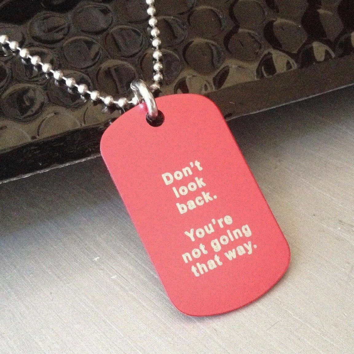 Pink dog tail necklace with Don't look back you're not going that way written in white