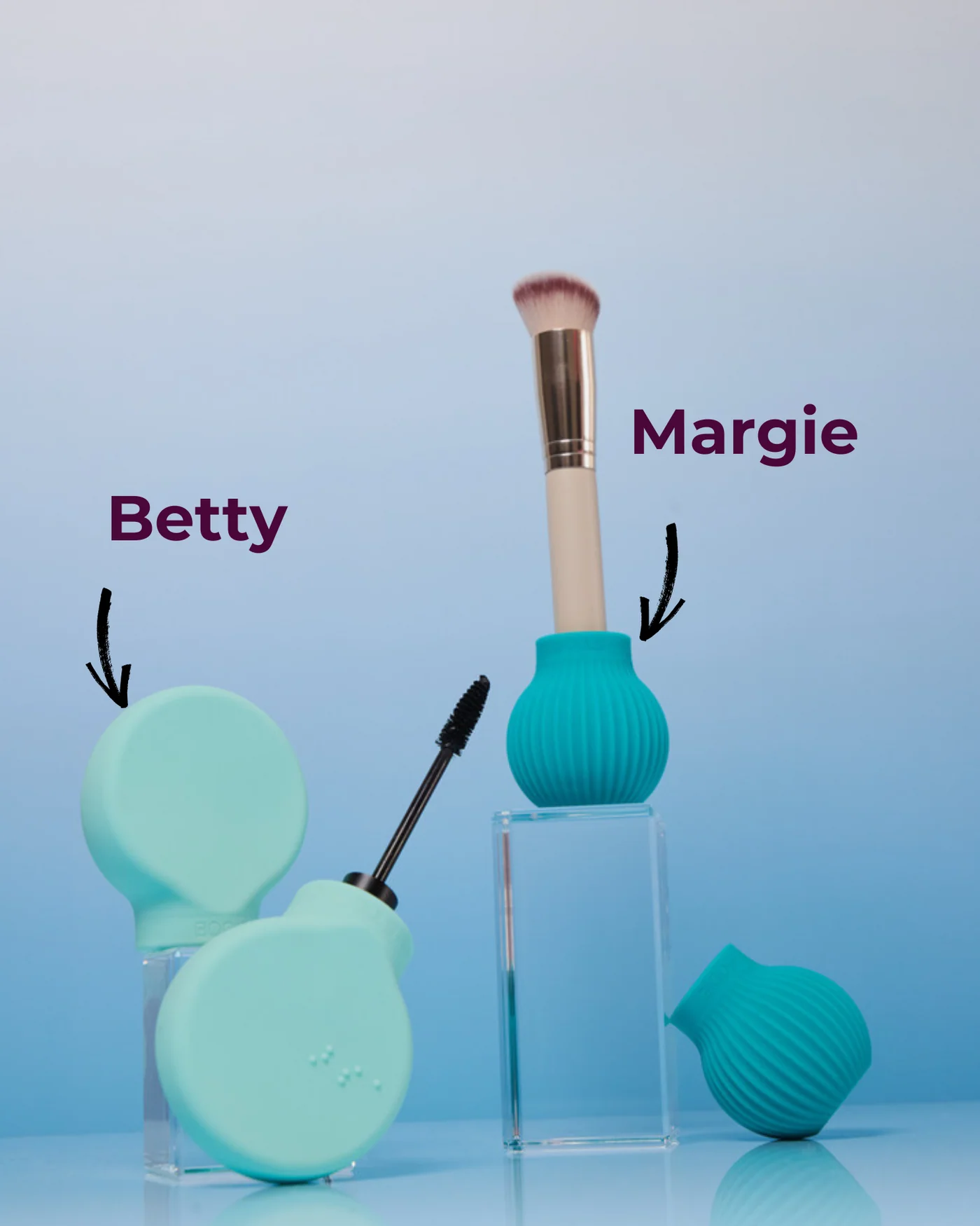 Accessible make up grip tools shown in mint green and turquoise.