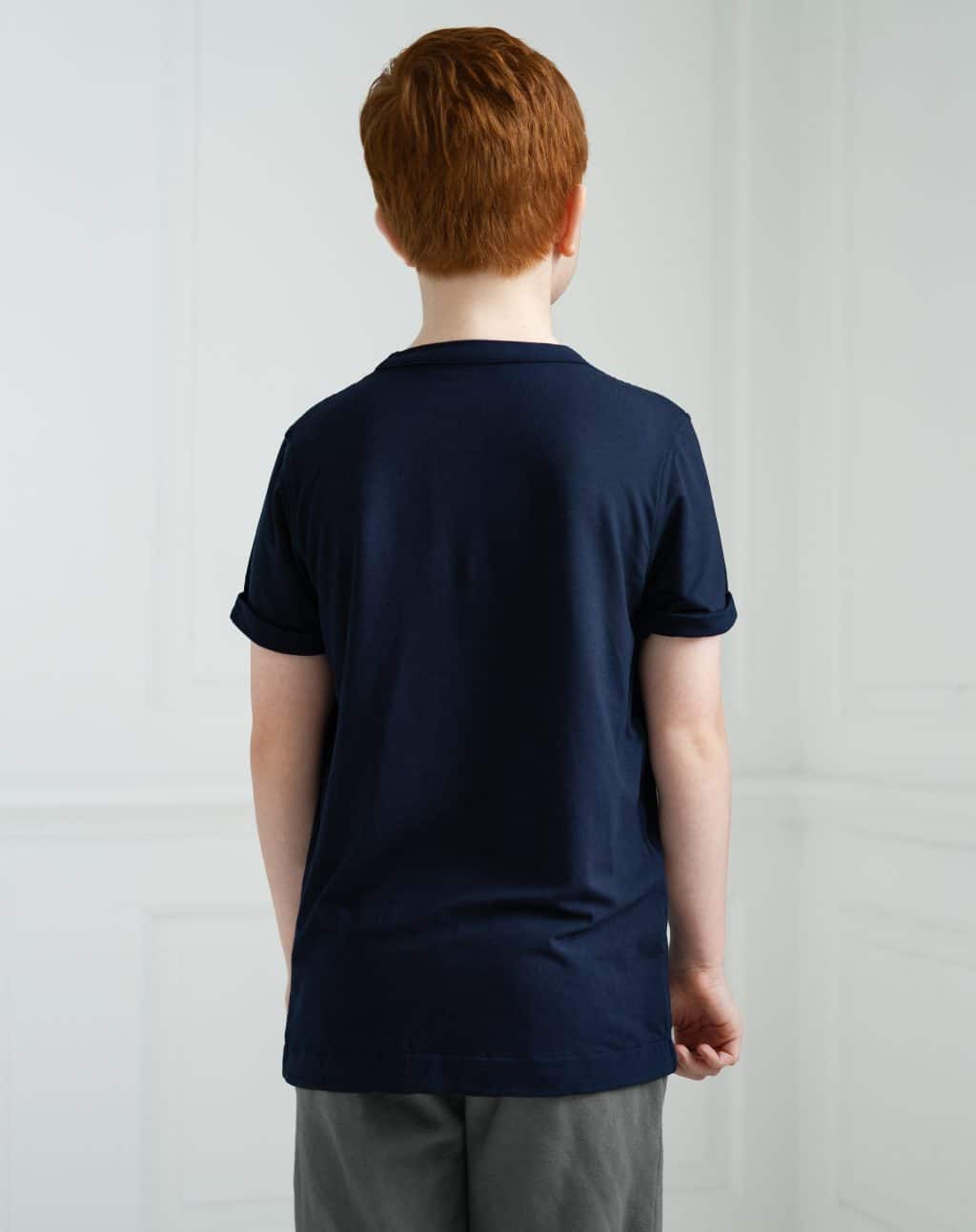 Boy with red hair shown shows the back of the t shirt