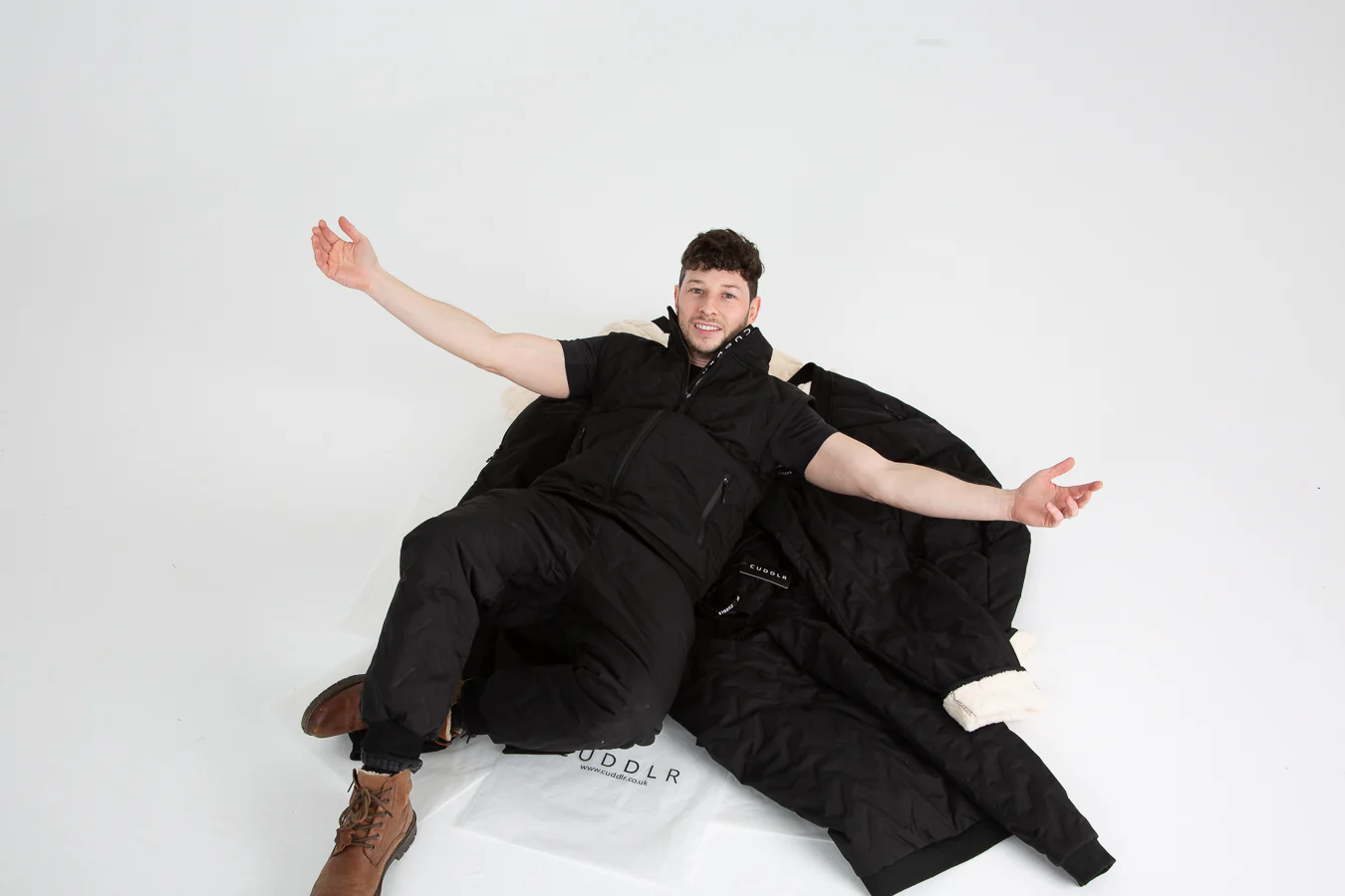 Founder Mike sits on a Cuddlr jacket spread out on the floor