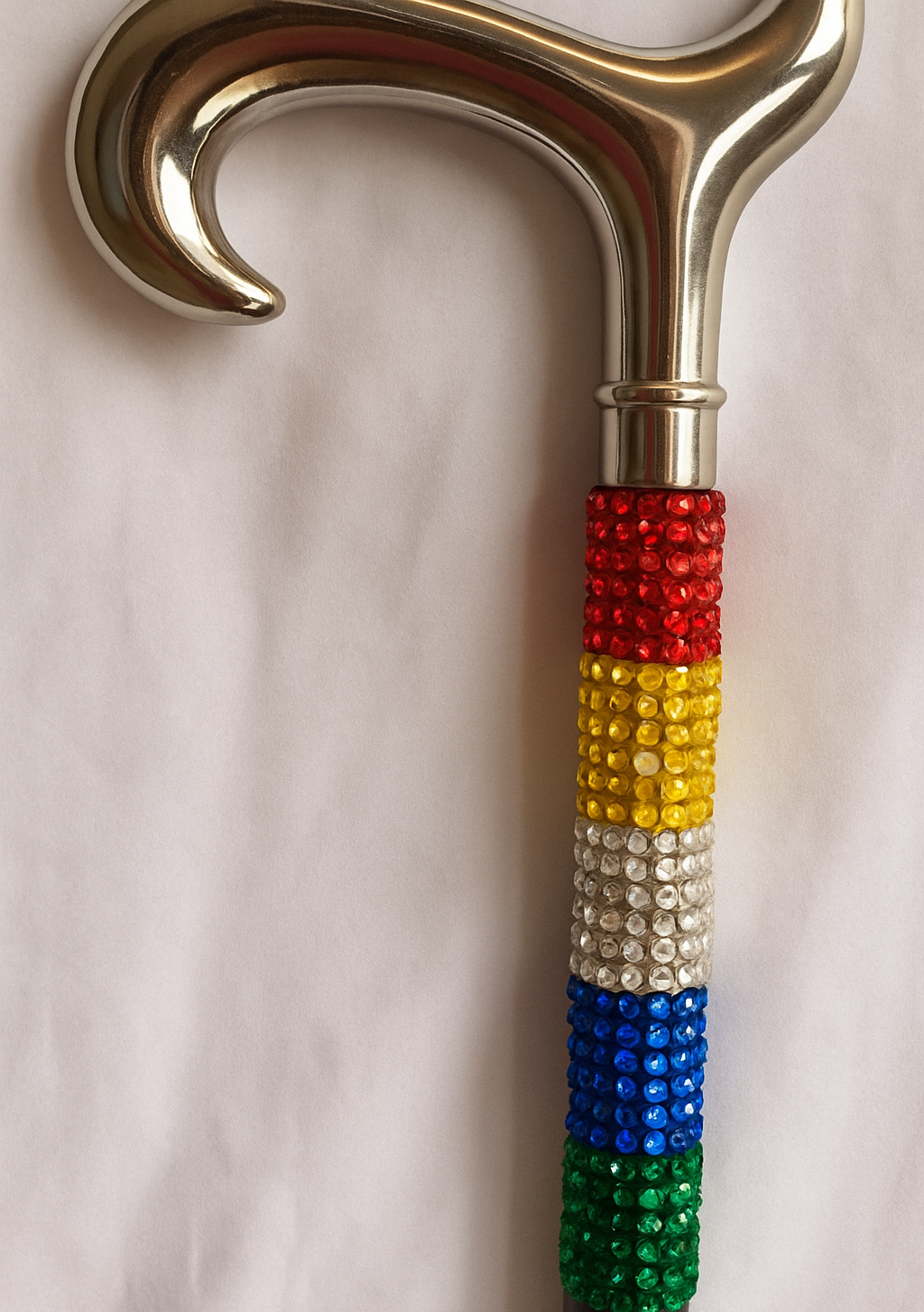 Rainbow coloured bewjelled walking stick with shiny goldhandle