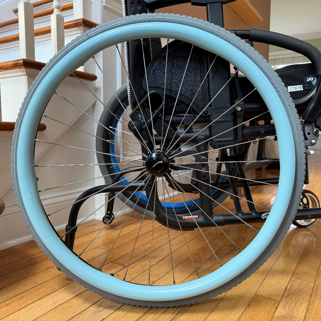 Pale blue trim on wheelchair tyre