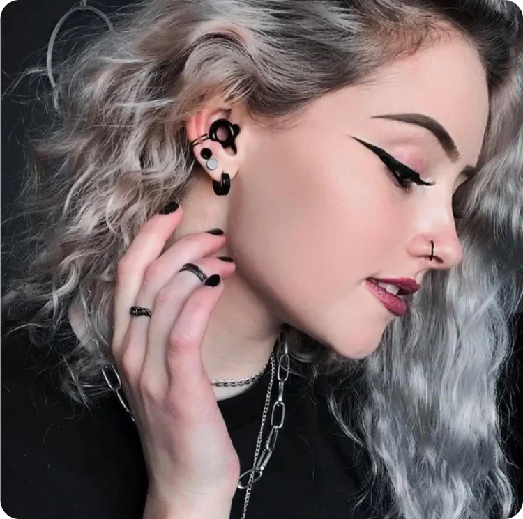 Woman wears earplugs in black