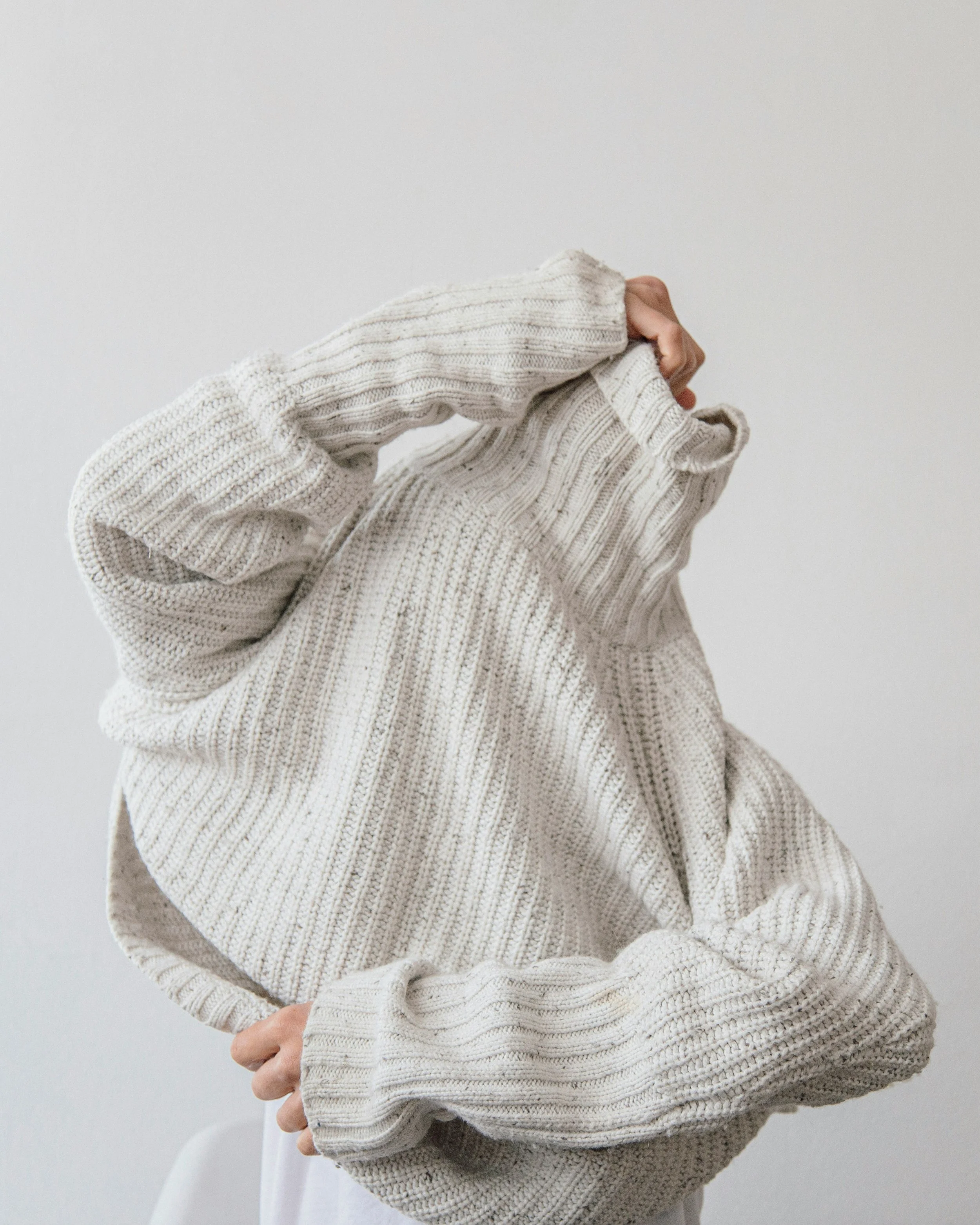 Woman removes jumper covering her face