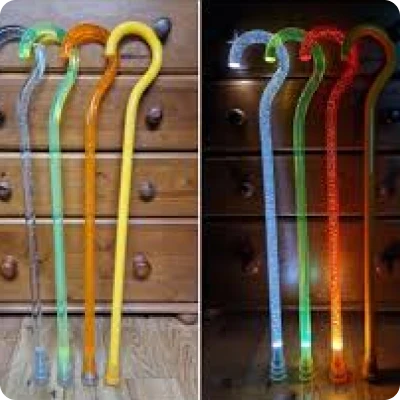 two images show the neo walk L E D walking sticks in daylight and the second image shows the LED light showing in the dark