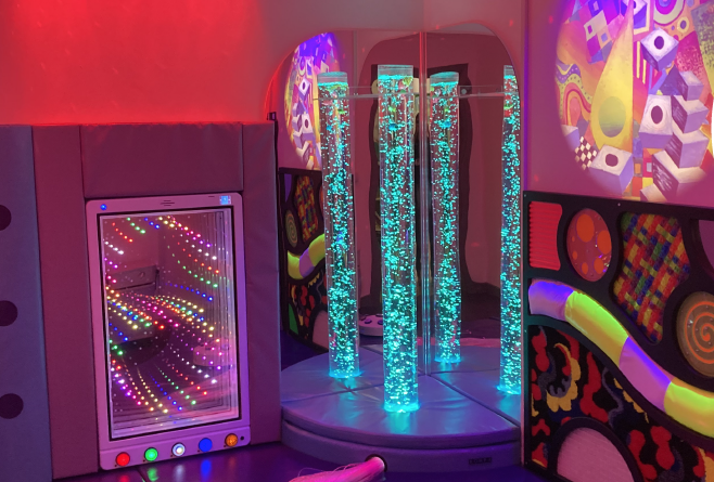 multi sensory room showing bubble tubes and soft play options