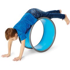a boy plays with a blue climbing wheel for gross motor skills