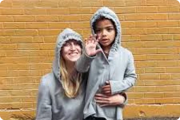 mother and son wearing a grey hoodie