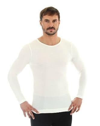 Man wears seam free long sleeve t shirt in white merino wool