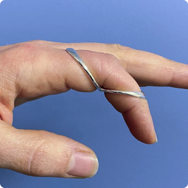 model wearing forced flexion splint in silver metal colour