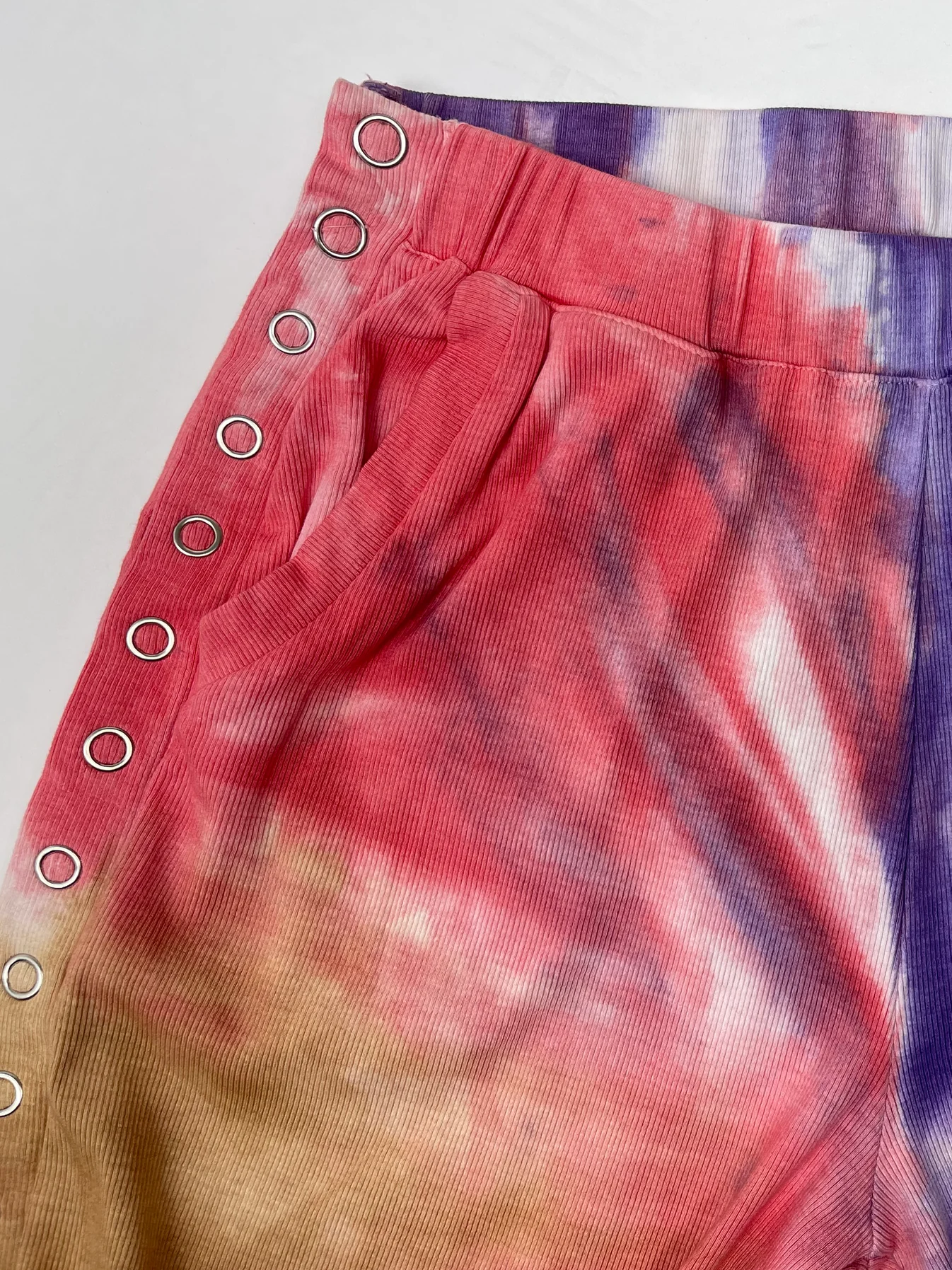 Colourful tie dye shorts with side popper fastening 