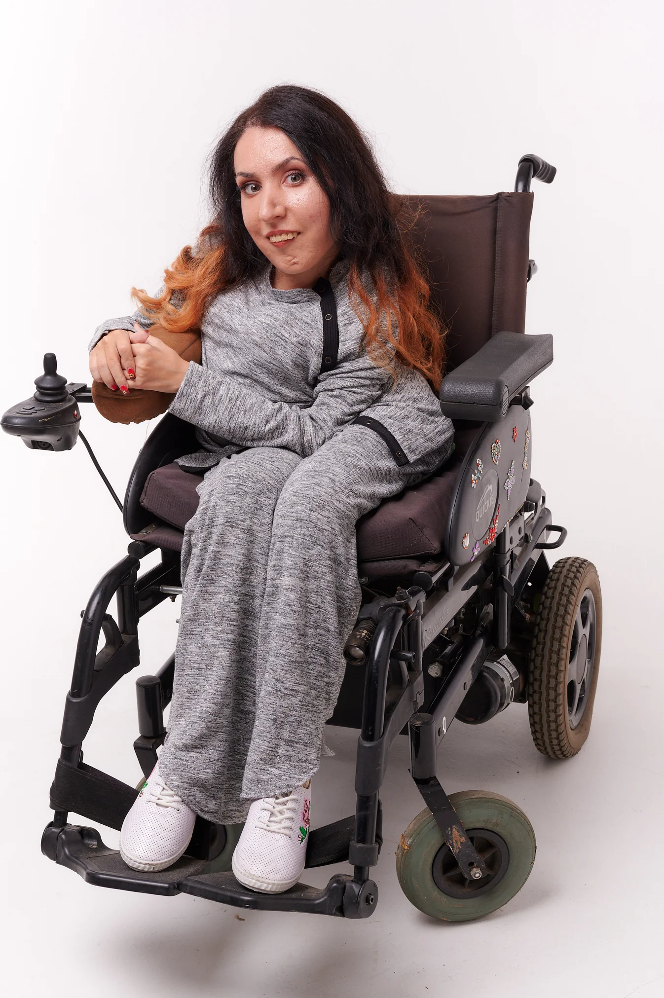 Woman in wheelchair wears Athleisure top and trousers in grey