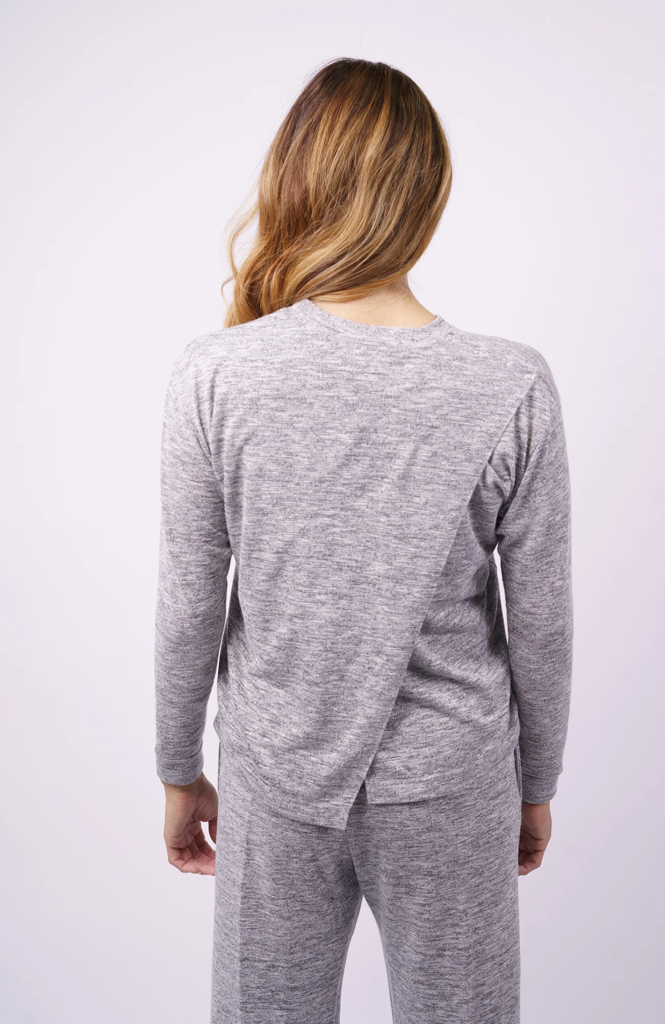 Woman wears Athleisure rear opening top in grey
