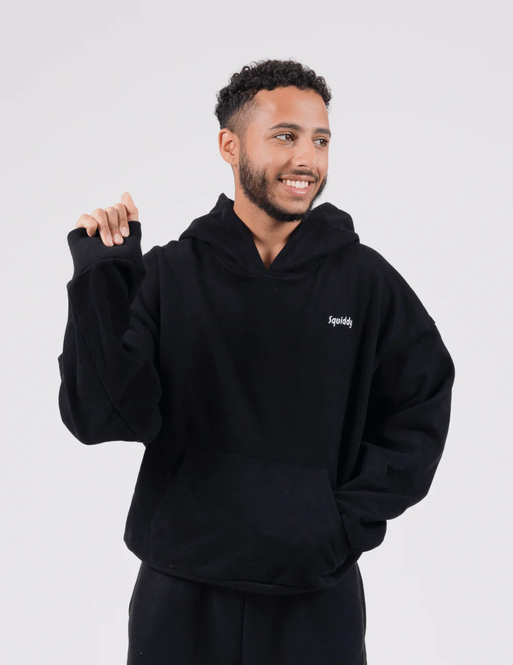 Man wears black hoodie and demonstrates the padded wrist