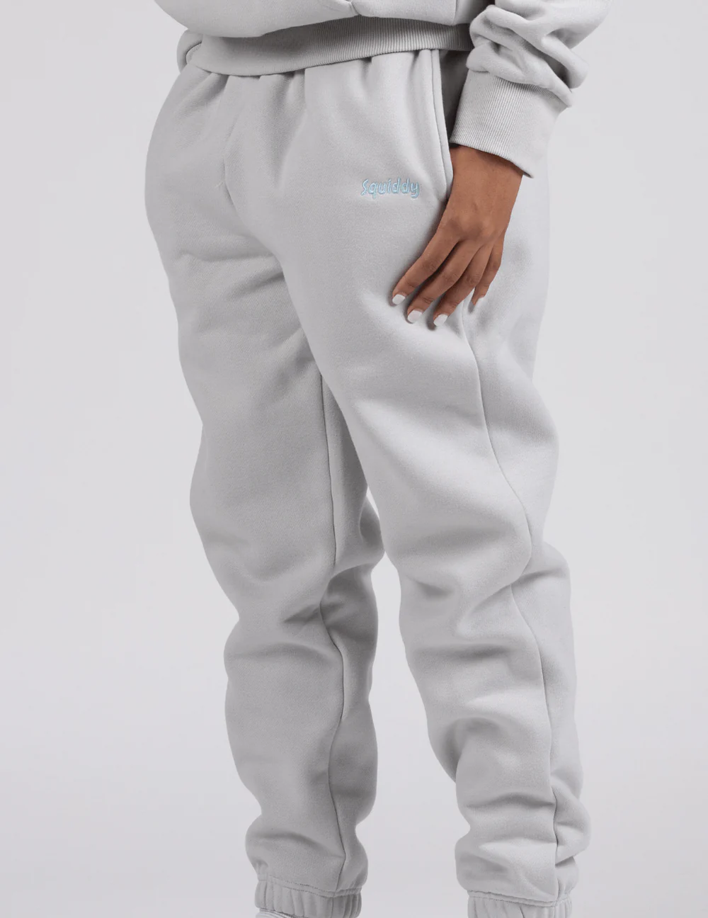 Man wears joggers in pale grey