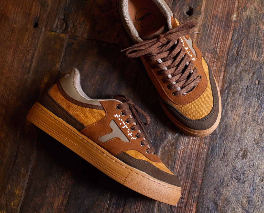 Brown trainers with a T for Timpers and braille