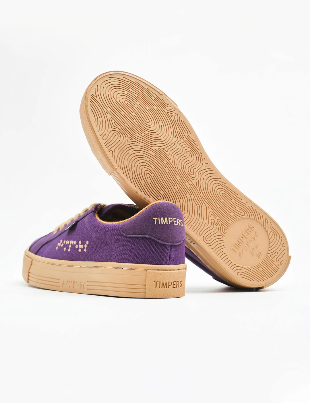 Purple trainers with braille on the side