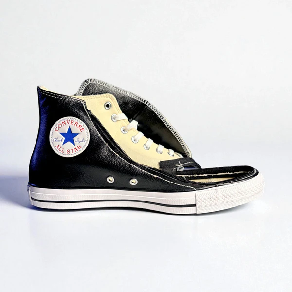 Converse shoe in black shown with zip open