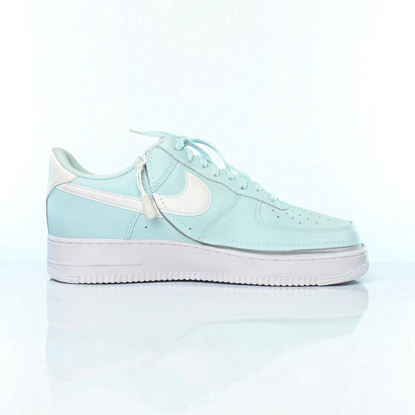 Women's Nike trainer in mint green shown with zip