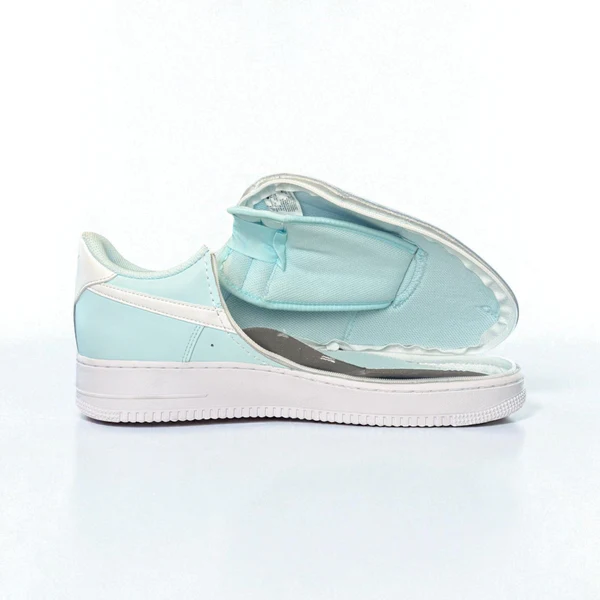 Women's Nike trainer in mint green shown with zip fully open